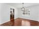 Dining room featuring hardwood floors, wainscoting, and modern lighting at 6107 Waterton Dr, Lithonia, GA 30058