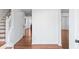 Interior entryway with beautiful hardwood floors, white walls, staircase and a view into other rooms at 6107 Waterton Dr, Lithonia, GA 30058