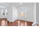 Bright foyer featuring hardwood floors, decorative glass door, and white trim at 6107 Waterton Dr, Lithonia, GA 30058