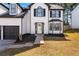 Beautiful two-story home with attached two-car garage, mulch landscaping and charming entryway at 6107 Waterton Dr, Lithonia, GA 30058