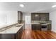 Modern kitchen featuring stainless steel appliances, dark cabinets, and hardwood floors at 6107 Waterton Dr, Lithonia, GA 30058