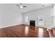 Spacious living room featuring a fireplace, ceiling fan, and wood flooring at 6107 Waterton Dr, Lithonia, GA 30058