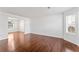 Open living room with hardwood floors, natural light, and neutral paint at 6107 Waterton Dr, Lithonia, GA 30058