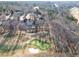 Aerial view of a neighborhood featuring large homes, a golf course, lush greenery, and picturesque views at 10 Club Ct, Alpharetta, GA 30005