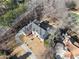 An aerial view shows the grand home featuring mature trees, a circular driveway, and lush landscaping at 10 Club Ct, Alpharetta, GA 30005