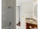 Bathroom featuring tiled shower, sink with granite countertop, and access to a walk-in closet at 10 Club Ct, Alpharetta, GA 30005