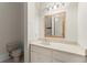 Bright bathroom featuring a wooden framed mirror, vanity, and a white countertop at 10 Club Ct, Alpharetta, GA 30005