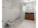 Bathroom with marble floors and walls, a glass block shower divider, and custom wood cabinets at 10 Club Ct, Alpharetta, GA 30005