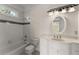 Clean bathroom with black and white tile, framed mirror and vanity at 10 Club Ct, Alpharetta, GA 30005