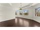 Bright bedroom featuring large windows, dark wood floors, and elegant crown molding at 10 Club Ct, Alpharetta, GA 30005