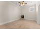 Cozy bedroom with a fireplace, neutral tile flooring, and a ceiling fan at 10 Club Ct, Alpharetta, GA 30005