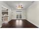 Bright bonus room with dark wood flooring, ceiling fan, and doors to a private balcony at 10 Club Ct, Alpharetta, GA 30005