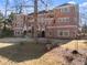 Stately brick home featuring multiple windows, balconies, arched entryways, and a well-manicured lawn at 10 Club Ct, Alpharetta, GA 30005