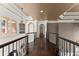 Elegant hallway features hardwood floors, ornamental lighting, decorative ceilings, and wrought iron railings at 10 Club Ct, Alpharetta, GA 30005