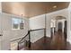 Hallway with dark hardwood floors, decorative railing, and custom light fixture at 10 Club Ct, Alpharetta, GA 30005