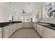 Open concept kitchen with black countertops, white cabinets, tile flooring, and stainless steel appliances at 10 Club Ct, Alpharetta, GA 30005