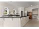 Bright kitchen with an island, white cabinetry, stainless steel appliances, and a window overlooking the backyard at 10 Club Ct, Alpharetta, GA 30005