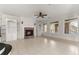 Open living room with decorative fireplace, ceiling fan and built in bookshelves at 10 Club Ct, Alpharetta, GA 30005