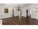 Living room with dark hardwood floors, chandelier, fireplace, and French doors at 10 Club Ct, Alpharetta, GA 30005