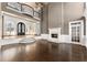 Living room featuring hardwood floors, fireplace, chandelier, and staircase to the second floor at 10 Club Ct, Alpharetta, GA 30005