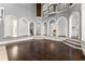 Open living space featuring hardwood floors, arched doorways and staircase at 10 Club Ct, Alpharetta, GA 30005