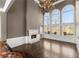 Spacious living room featuring tall windows, fireplace, chandelier, and hardwood floors at 10 Club Ct, Alpharetta, GA 30005