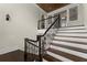 Elegant staircase with dark wood railings and white risers, adding architectural detail at 10 Club Ct, Alpharetta, GA 30005