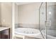 Elegant bathroom with a built-in oval bathtub and glass-enclosed shower at 1199 Huff Rd # 121, Atlanta, GA 30318