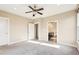 Open bedroom featuring neutral walls, carpet, ceiling fan, with an open view into the Primary bathroom at 1199 Huff Rd # 121, Atlanta, GA 30318