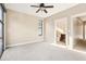 Spacious bedroom featuring neutral walls, a ceiling fan, and an attached bathroom at 1199 Huff Rd # 121, Atlanta, GA 30318