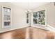 Sunlit dining room with hardwood floors and large windows at 1199 Huff Rd # 121, Atlanta, GA 30318