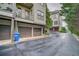 View of townhome garages and balconies with a private driveway at 1199 Huff Rd # 121, Atlanta, GA 30318