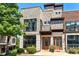 Stunning townhouse with a stone facade, large windows, and a welcoming entrance at 1199 Huff Rd # 121, Atlanta, GA 30318