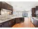 Open kitchen featuring stainless appliances, dark wood cabinetry, and granite countertops at 1199 Huff Rd # 121, Atlanta, GA 30318