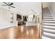 Open-concept living area featuring hardwood floors, modern kitchen, and a staircase at 1199 Huff Rd # 121, Atlanta, GA 30318