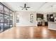 Bright living room with hardwood floors, large windows, and an open flow to the kitchen at 1199 Huff Rd # 121, Atlanta, GA 30318