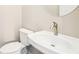 Contemporary powder room featuring a pedestal sink with modern faucet and low-flow toilet at 1199 Huff Rd # 121, Atlanta, GA 30318