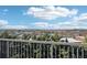 Scenic view from balcony through iron railing with green trees in the foreground and skyline beyond at 1199 Huff Rd # 121, Atlanta, GA 30318