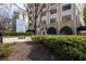 Entrance to high-rise building with beautifully landscaped greenery and modern sculpture at 2479 Peachtree Ne Rd # 912, Atlanta, GA 30305