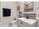 Bathroom features a single sink vanity, framed mirror, and tile backsplash at 4270 Pleasant Woods Dr, Cumming, GA 30028