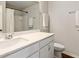 Bright bathroom featuring a white vanity, a large mirror, and a shower with a neutral shower curtain at 4270 Pleasant Woods Dr, Cumming, GA 30028