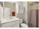 Well-lit bathroom with a white vanity, cabinet, toilet, and shower with a neutral-patterned shower curtain at 4270 Pleasant Woods Dr, Cumming, GA 30028