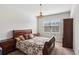 Bedroom with traditional-style furniture, warm-toned bedding, and a chandelier adding a cozy ambiance at 4270 Pleasant Woods Dr, Cumming, GA 30028