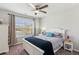 Comfortable bedroom with a white bed frame, neutral-toned bedding, and natural light from the window at 4270 Pleasant Woods Dr, Cumming, GA 30028