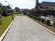 View of community bocce ball court surrounded by well-maintained landscaping and lush green lawns at 4270 Pleasant Woods Dr, Cumming, GA 30028