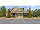 Community clubhouse with manicured landscaping and parking spaces, creating a welcoming entrance at 4270 Pleasant Woods Dr, Cumming, GA 30028