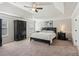 A cozy main bedroom featuring a tray ceiling, neutral paint, and coordinating furniture at 4270 Pleasant Woods Dr, Cumming, GA 30028