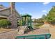 Community playground with wood structure and green slide, near trees and other community amenities at 4270 Pleasant Woods Dr, Cumming, GA 30028