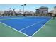 Community tennis court featuring blue and green playing surfaces and well-maintained nets at 4270 Pleasant Woods Dr, Cumming, GA 30028