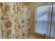 The bathroom has a floral curtain with natural light shining through the window at 500 Bainbridge Dr, Atlanta, GA 30327